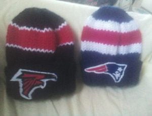 A couple caps and two cats. Get your hands on unique hand-knitted hats with NFL logos at Joann's! Our expert knitting and crocheting skills make for the perfect one-of-a-kind accessory. Joann's is your one-stop shop for all things kitting and crocheting. From hand-knitted caps to cute NFL logo designs, we have everything you need to perfect your craft. Shop now!